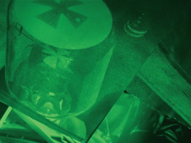 A digitally manipulated image blending close-ups of technology parts, with a bright green tinged colour overlay