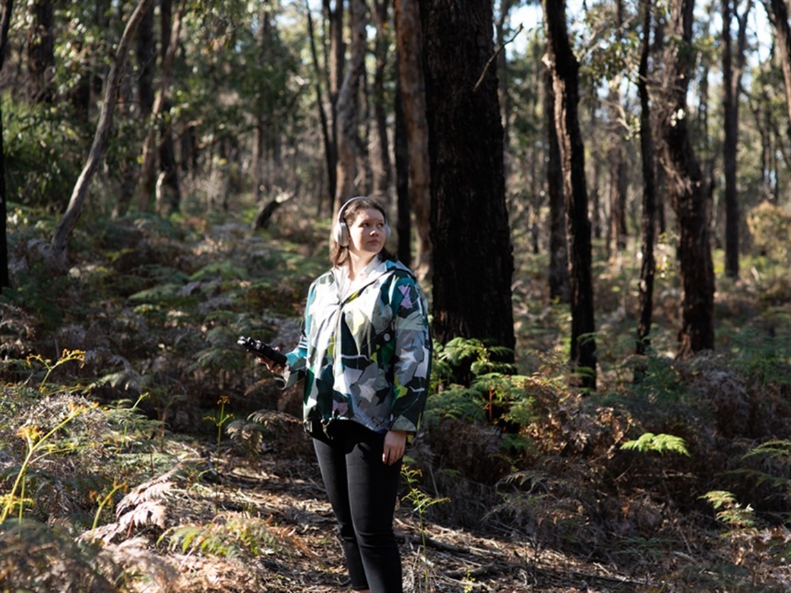 A photo taken in Point Addis of artist Lucy Allinson  with her sound equipment.  