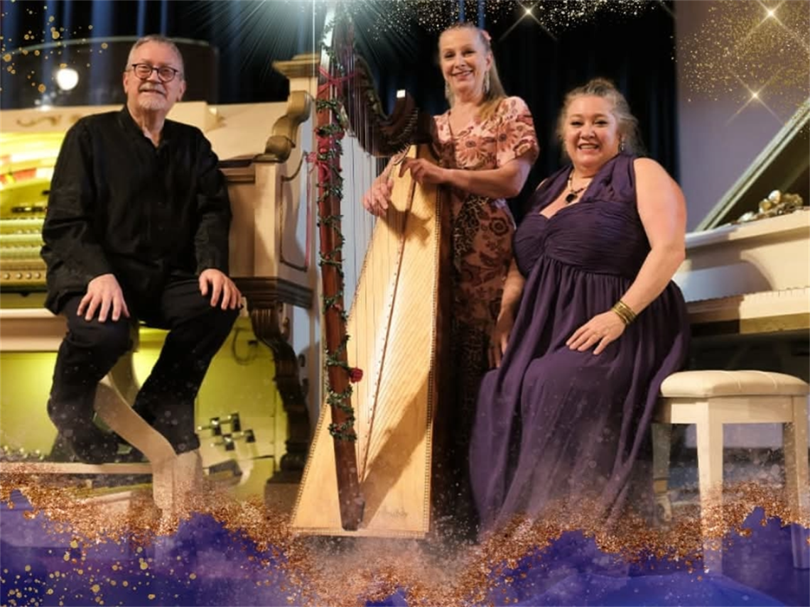 Three musicians two sitting one standing in front of a harp, piano and organ.