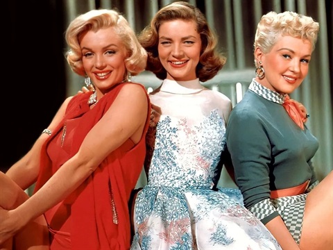 Three woman sitting next to each other facing the camera