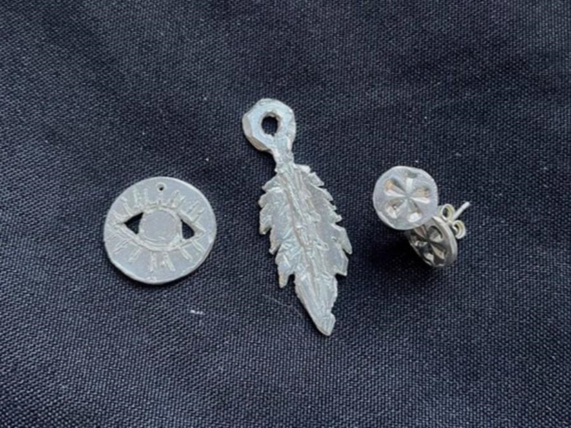 Three small silver pendants 