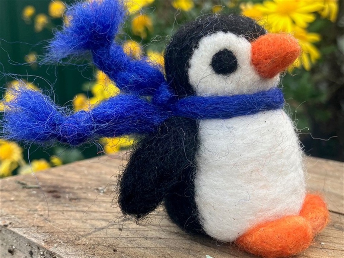 Felted penguin with a blue scarf