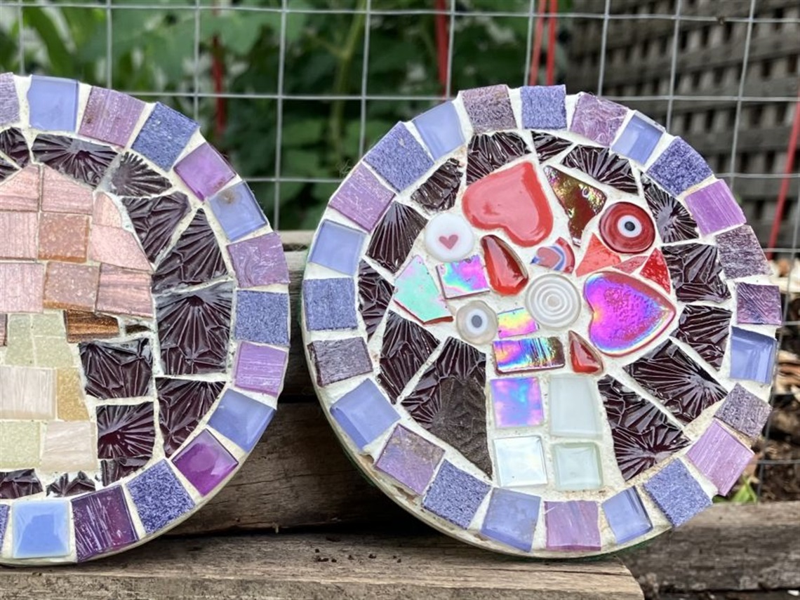 Two round coasters made from colourful mosaics with purple border