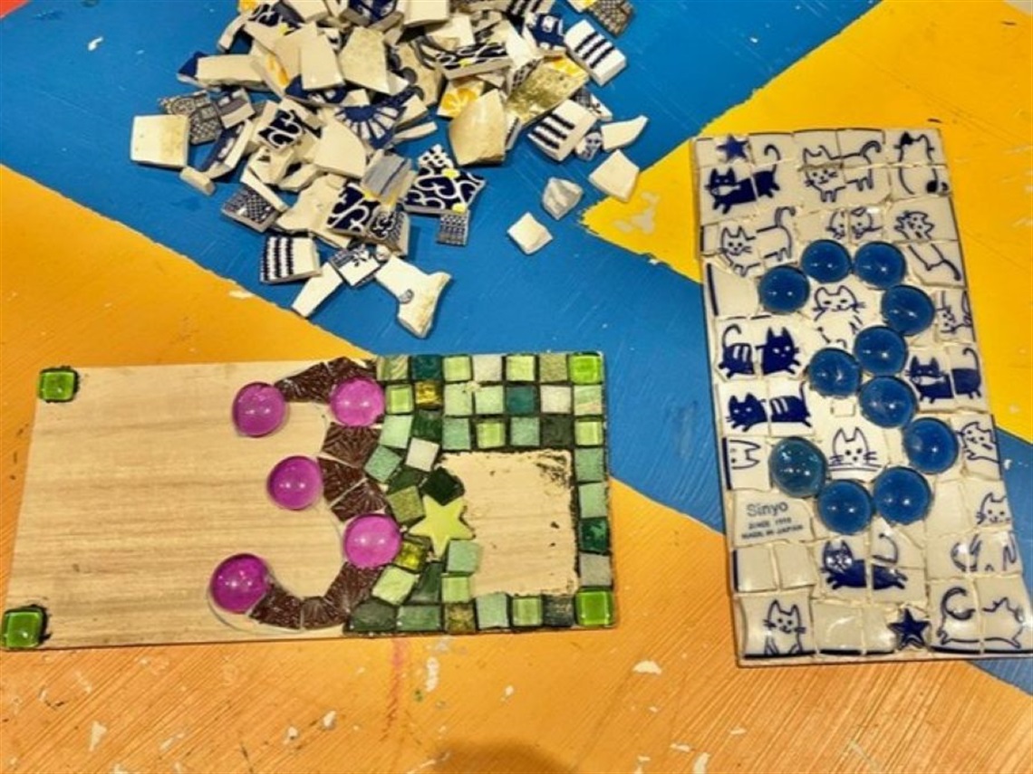 Two mosaic house numbers in progress and not yet finished.