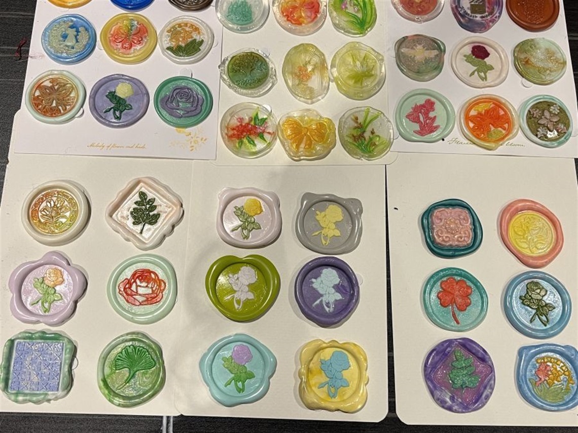 A tabletop full of assorted colourful wax seals