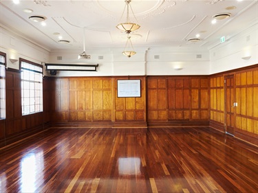 Polished wooden floors and walls of the Chamber, boasting old world charm.